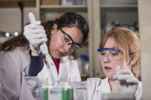 two students conducting lab experiment