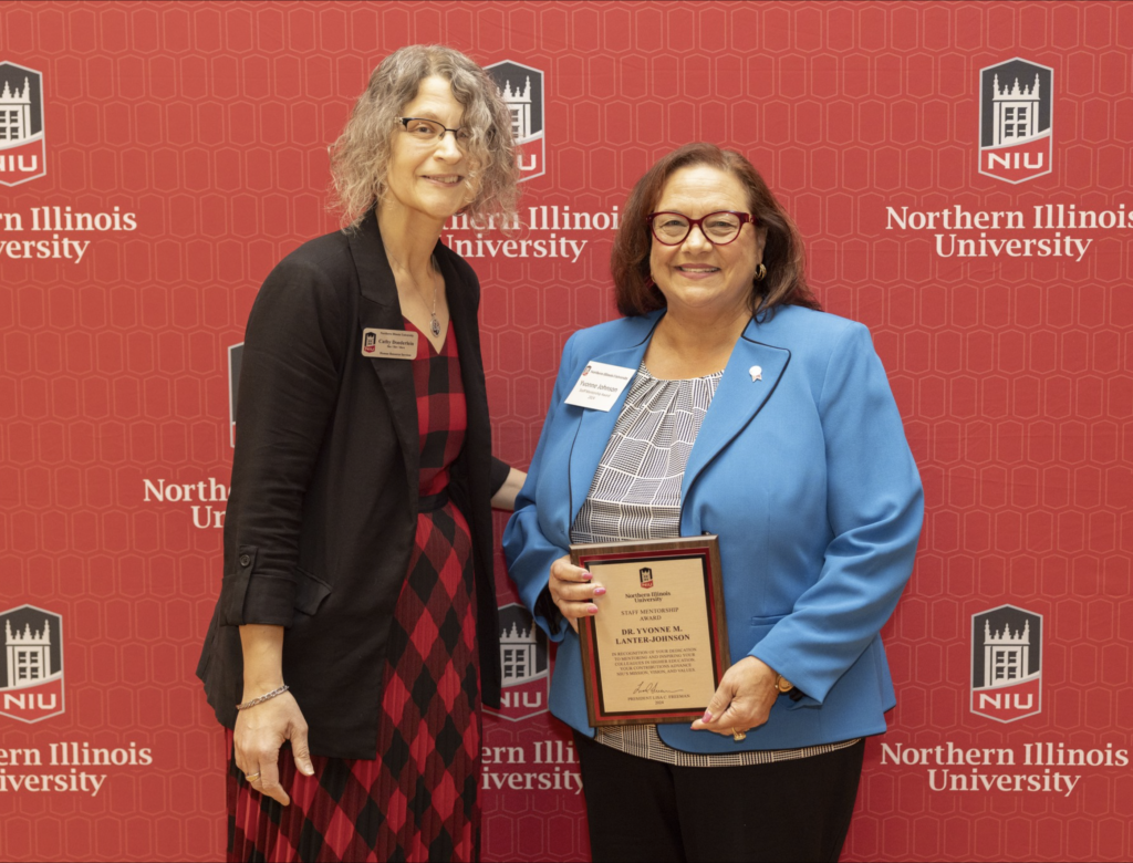 Yvonne Johnson accepts Staff Mentorship Award from Cathy Doederline.