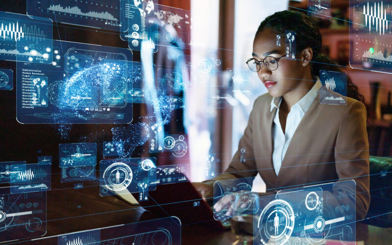 Young woman working on computer with computer algorithms superimposed