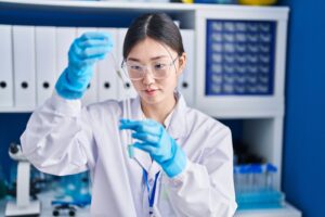 Chinese woman scientist fills test tube in a lab