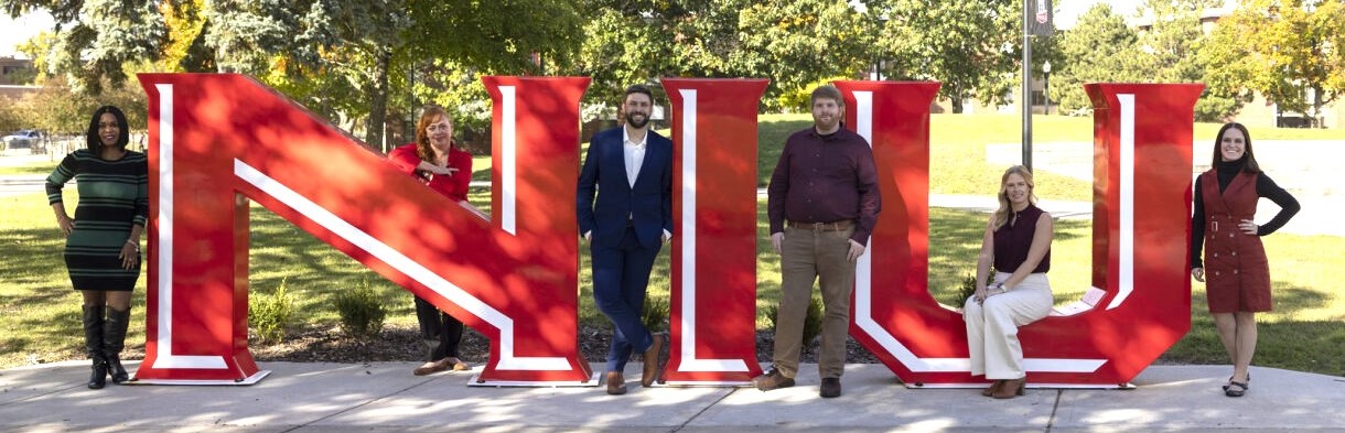 Online Learning team posing around NIU sign