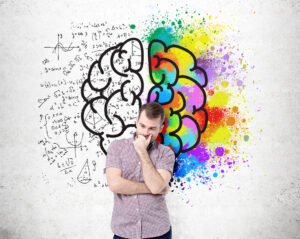 Right and left hemispheres, creative and analytical thinking concept with thoughtful man standing against concrete wall with sketch