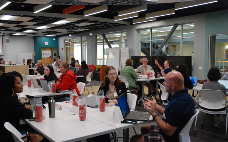 Faculty in De La Vega Innovation Lab discussing and collaborating