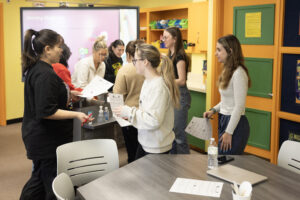 Students in Donna Werderich's classroom moving around and talking with each other during a learning activity. 