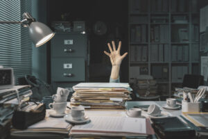 Desperate office worker overwhelmed with paperwork, she is asking help with her hand