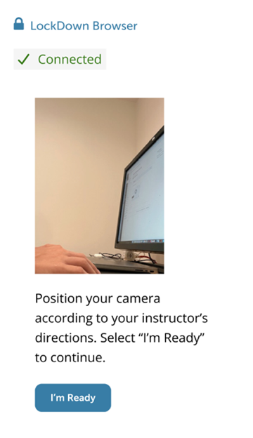LockDown Browser screen showing “Connected” status, a webcam preview of a person’s hand near a computer monitor, and instructions to position the camera before selecting “I’m Ready.”